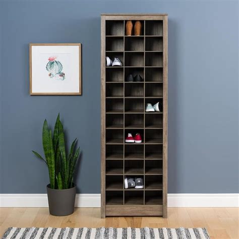 Lowes shoe storage - Offering ample space to stash up to 20 pairs of shoes, this storage cabinet is the perfect organizing solution for a cluttered entryway or bedroom. Crafted from manufactured wood, this budget-friendly piece features five interior shelves and three slatted doors that provide essential ventilation. A clean-lined silhouette and versatile dark walnut finish allow this design to blend in with a ...